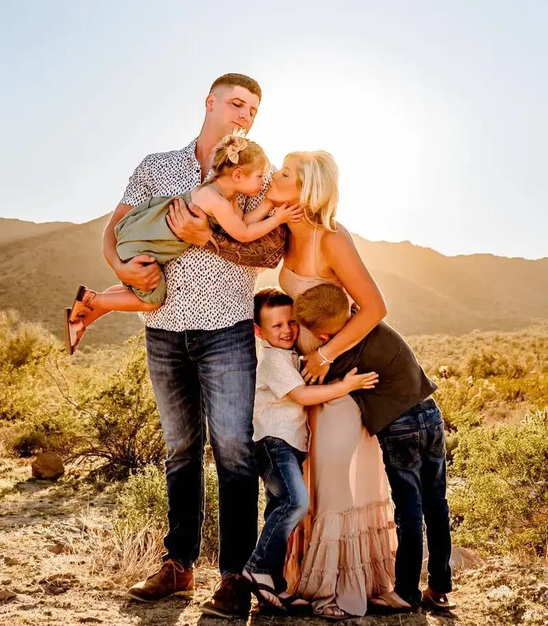 A family sharing a tender moment in the Tucson desert.