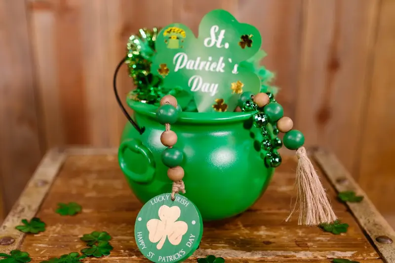 Green pot with St. Patrick's Day decor and beads.