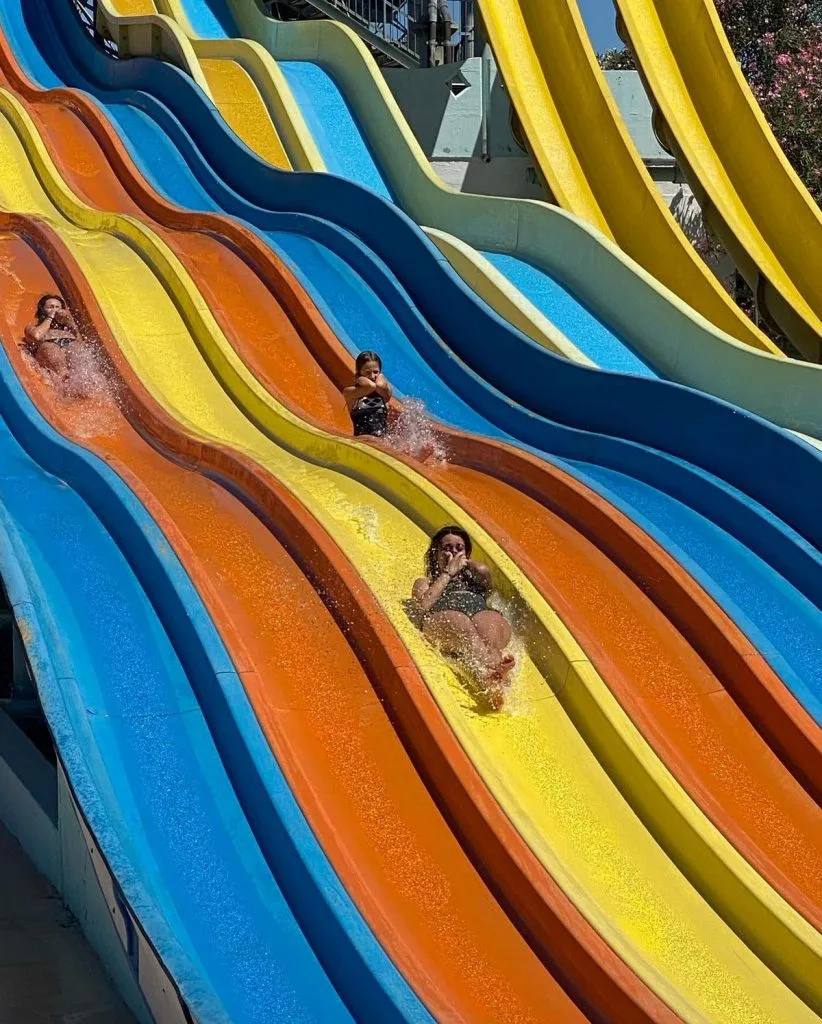 Thrill-seekers slide down colorful lanes at AcquaPark Odissea.