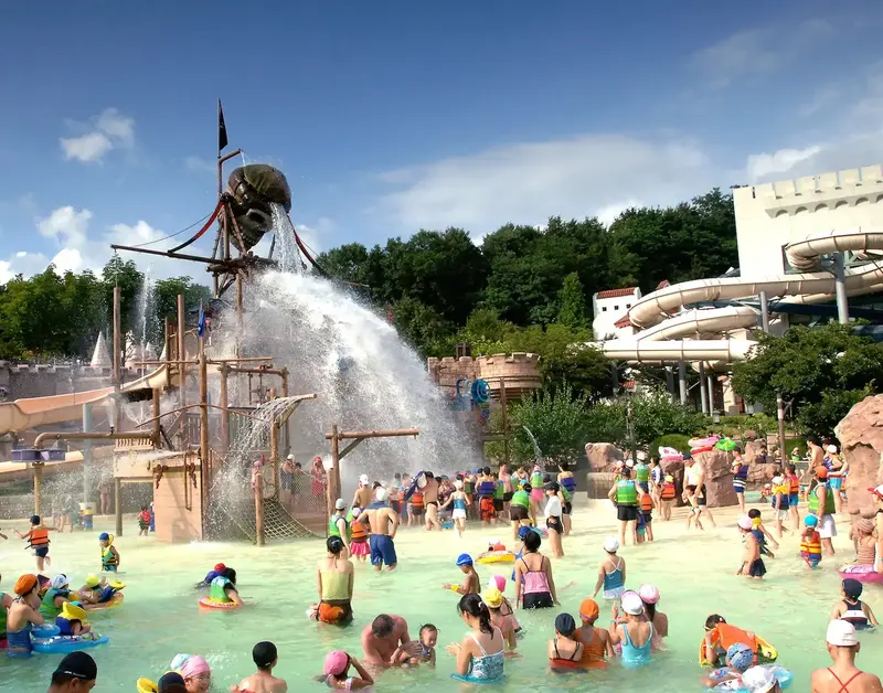 Families enjoy a pirate-themed splash zone at a water park.