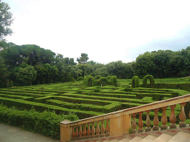 The meticulously trimmed hedges of the Labyrinth Park of Horta in Barcelona form an intricate maze, inviting visitors to lose themselves in its paths. The classical design of the labyrinth is framed by rich foliage and a traditional balustrade, embodying the tranquility and beauty of this historic garden