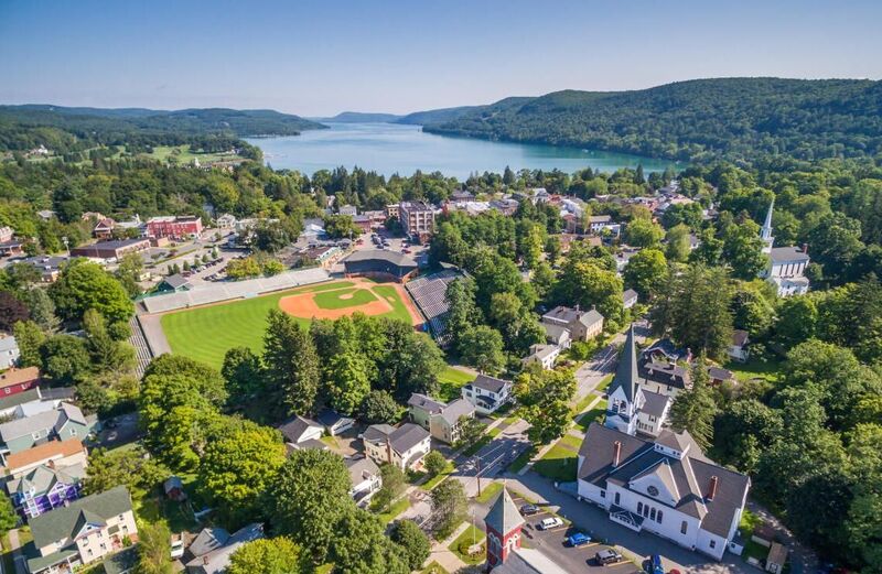Side view of the iconic Cooperstown baseball stadium with the National Baseball Hall of Fame in the foreground