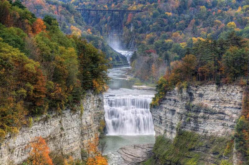 Autumn view of the majestic Letchworth State Park, showcasing the cascading waterfalls, deep gorges, and lush foliage