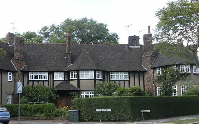 Traditional Tudor-style houses nestled among green foliage in Hampstead, London.