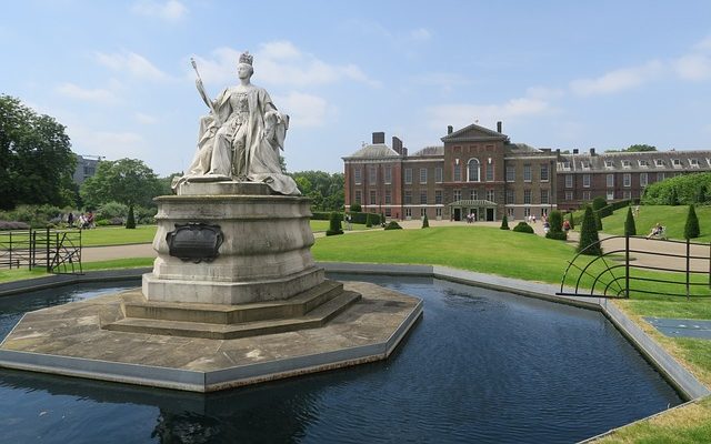 A majestic statue over waters of a fountain at Kensington Palace Gardens in London.