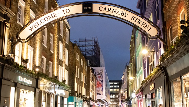 The welcoming arch of 'Carnaby Street' against the evening sky in Soho, London.