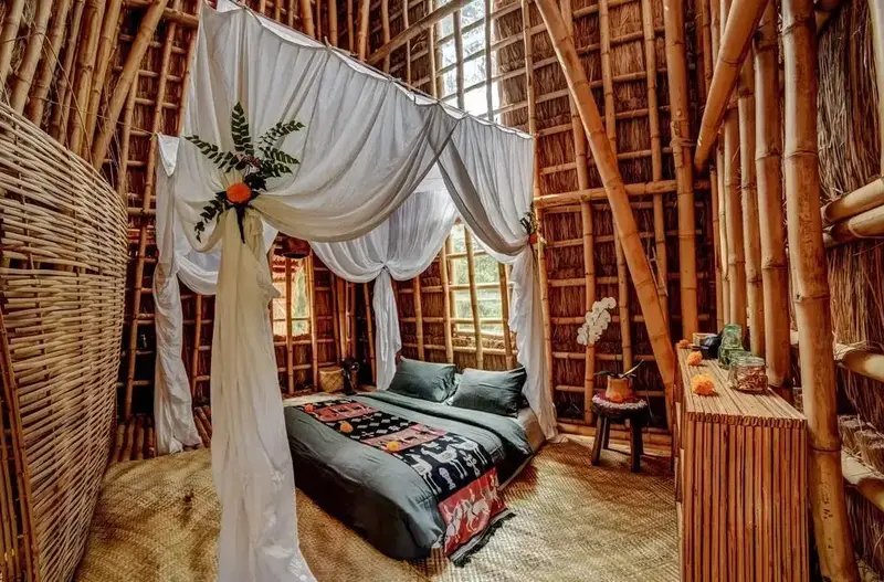 Bamboo-crafted room with a canopy bed.