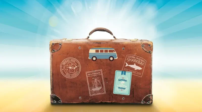 Vintage suitcase with travel stickers symbolizing summer trips and Paris travel tips.