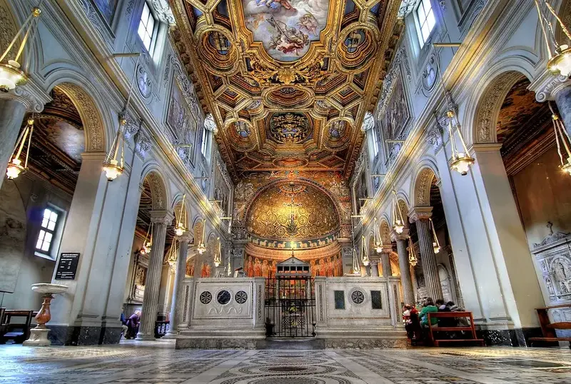 Lavish church interior with ornate golden ceiling.