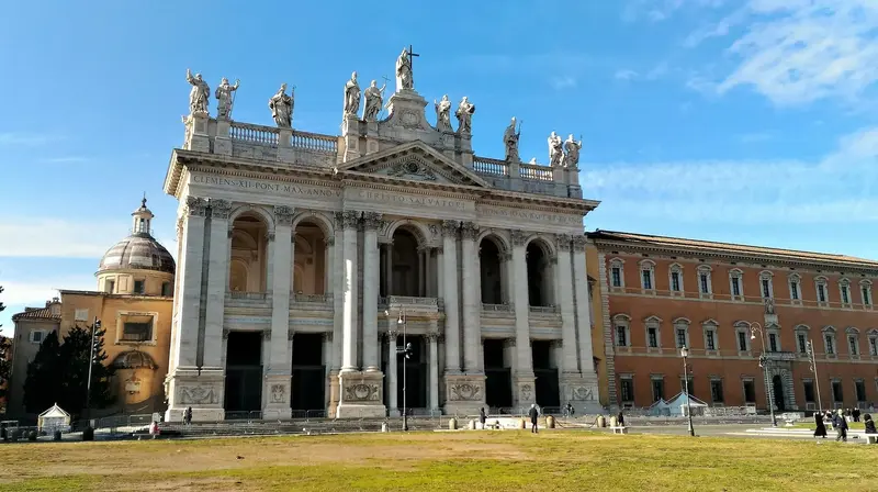 Iconic Roman church facade with statues and columns.
